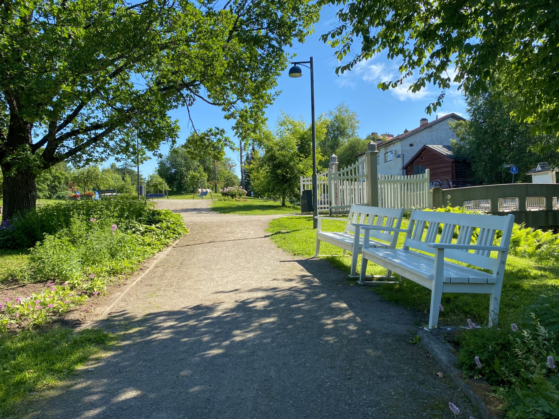 White park bench in the city park.