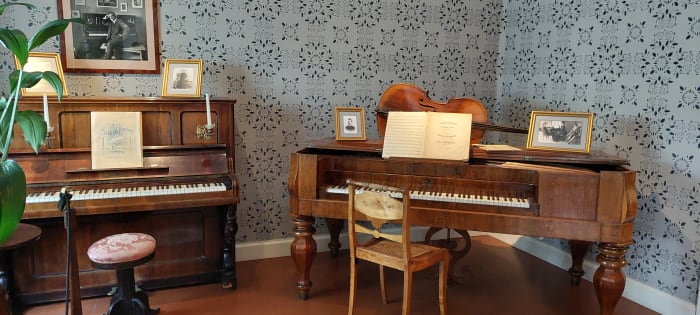 Interior photograph of Sibelius birthplace. In the picture there are two pianos from the 1900th century. 