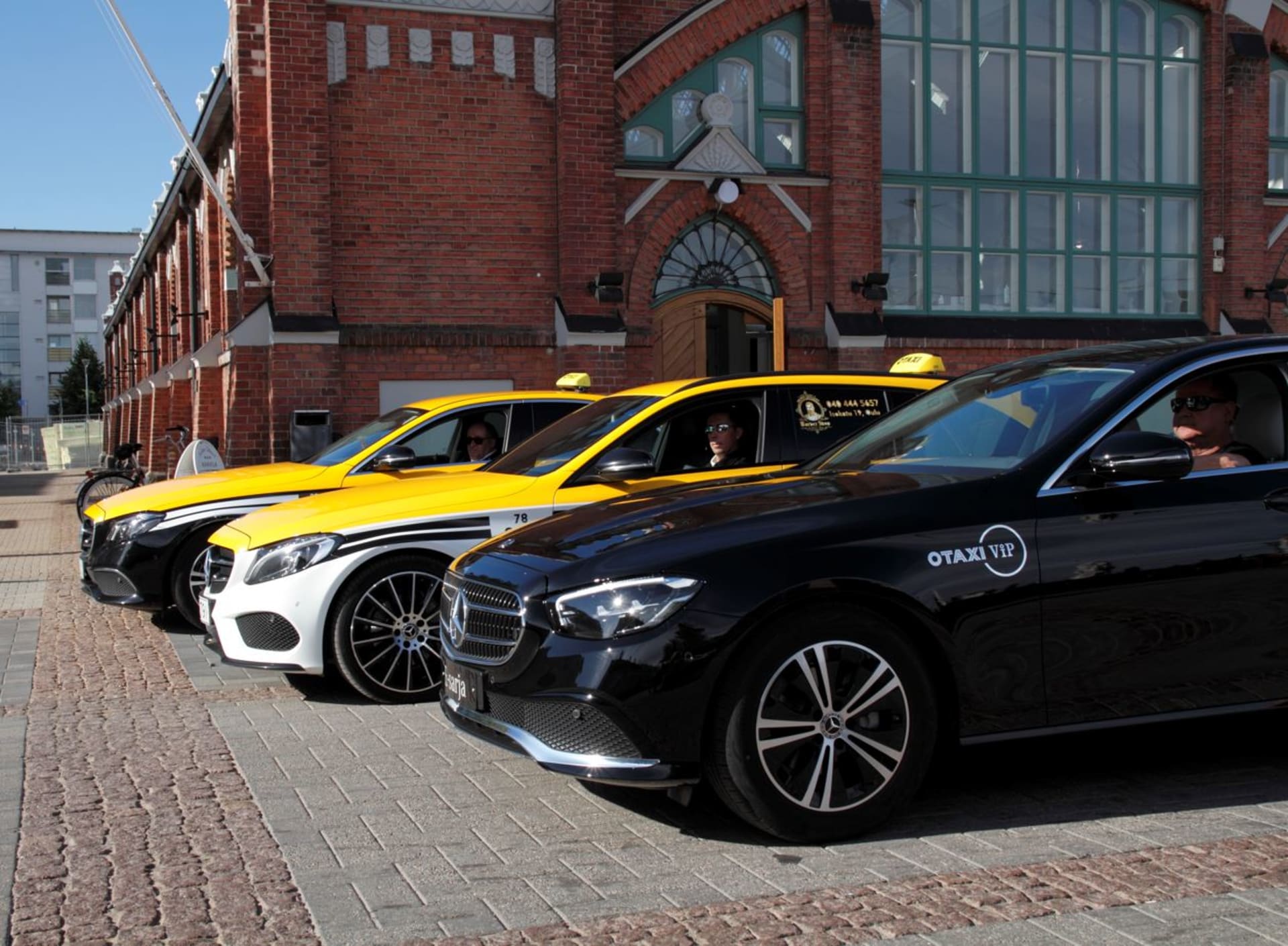 OTAXI VIP and yellow-roofed Otaxi taxis.