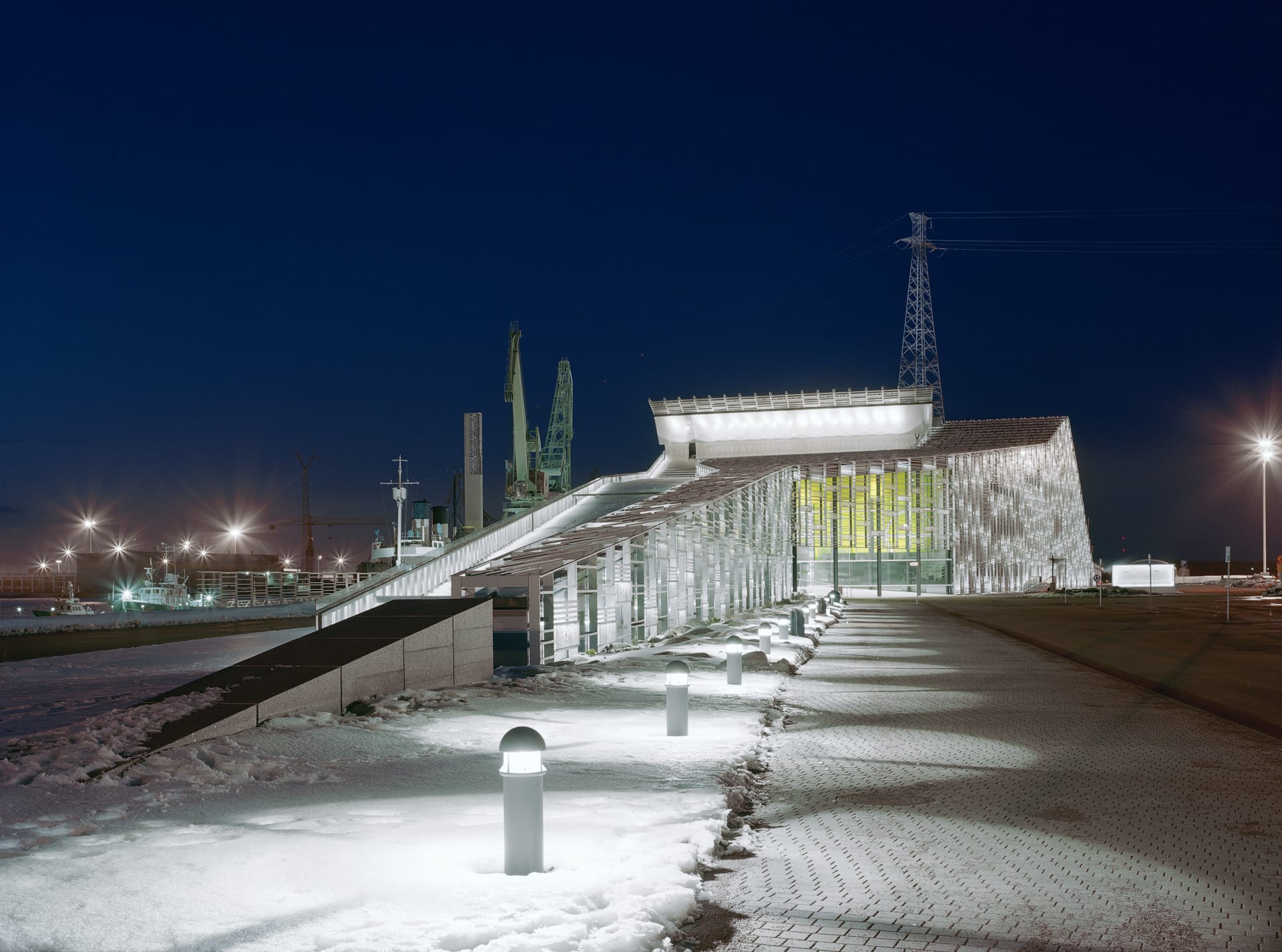 Frosty winter night with snow on the ground, Vellamo with lights shining. 
