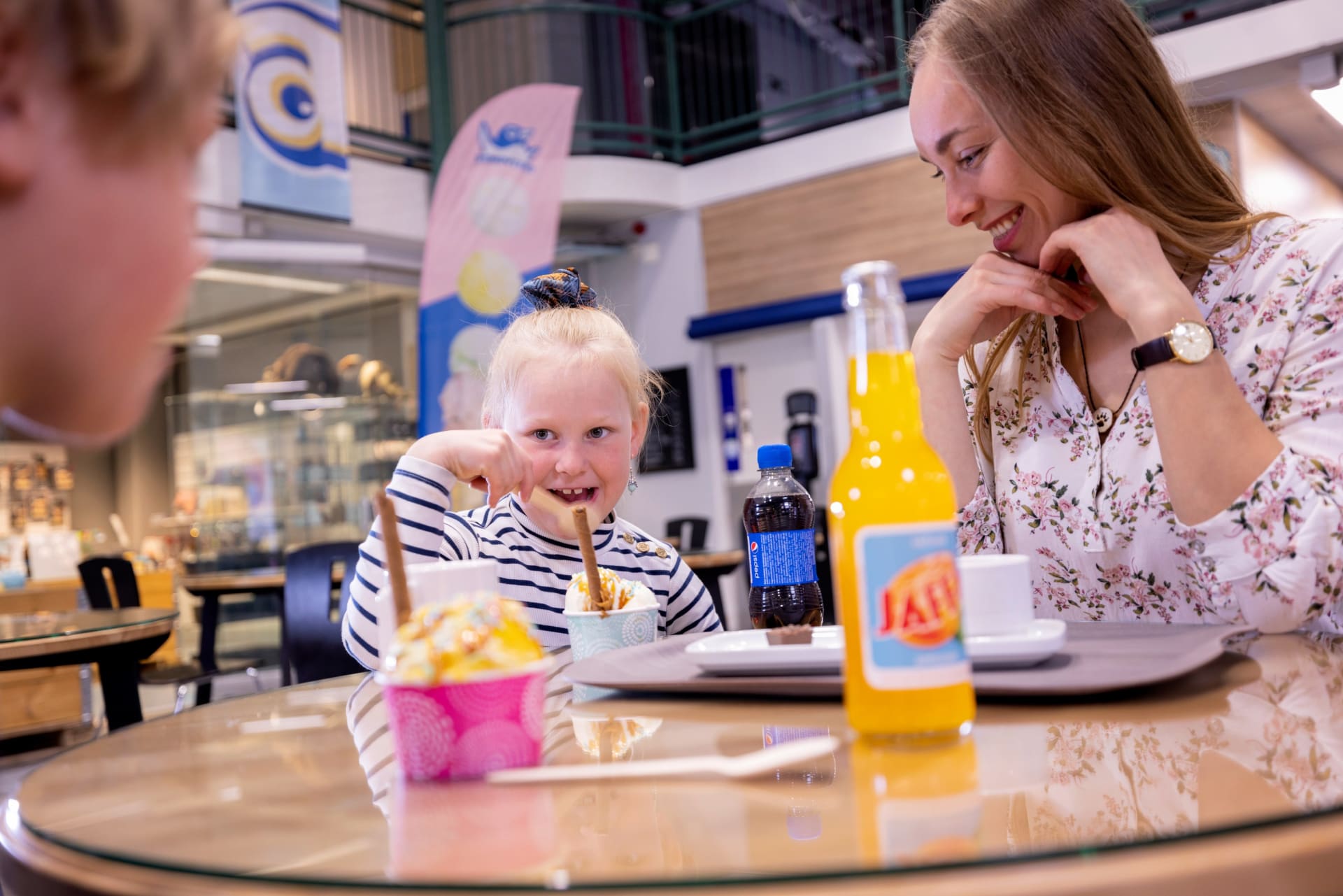 Smiling girl eating ice cream in the Science cafe.