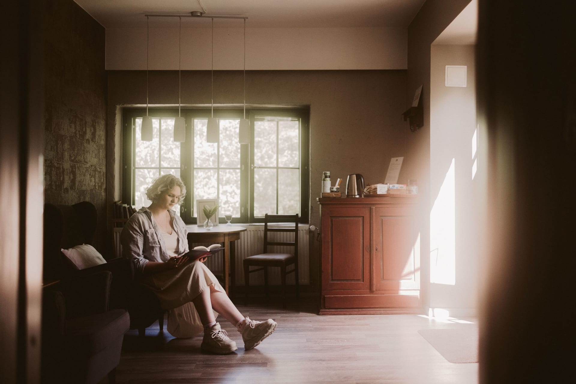 Guest reading a book at hotel lobby.