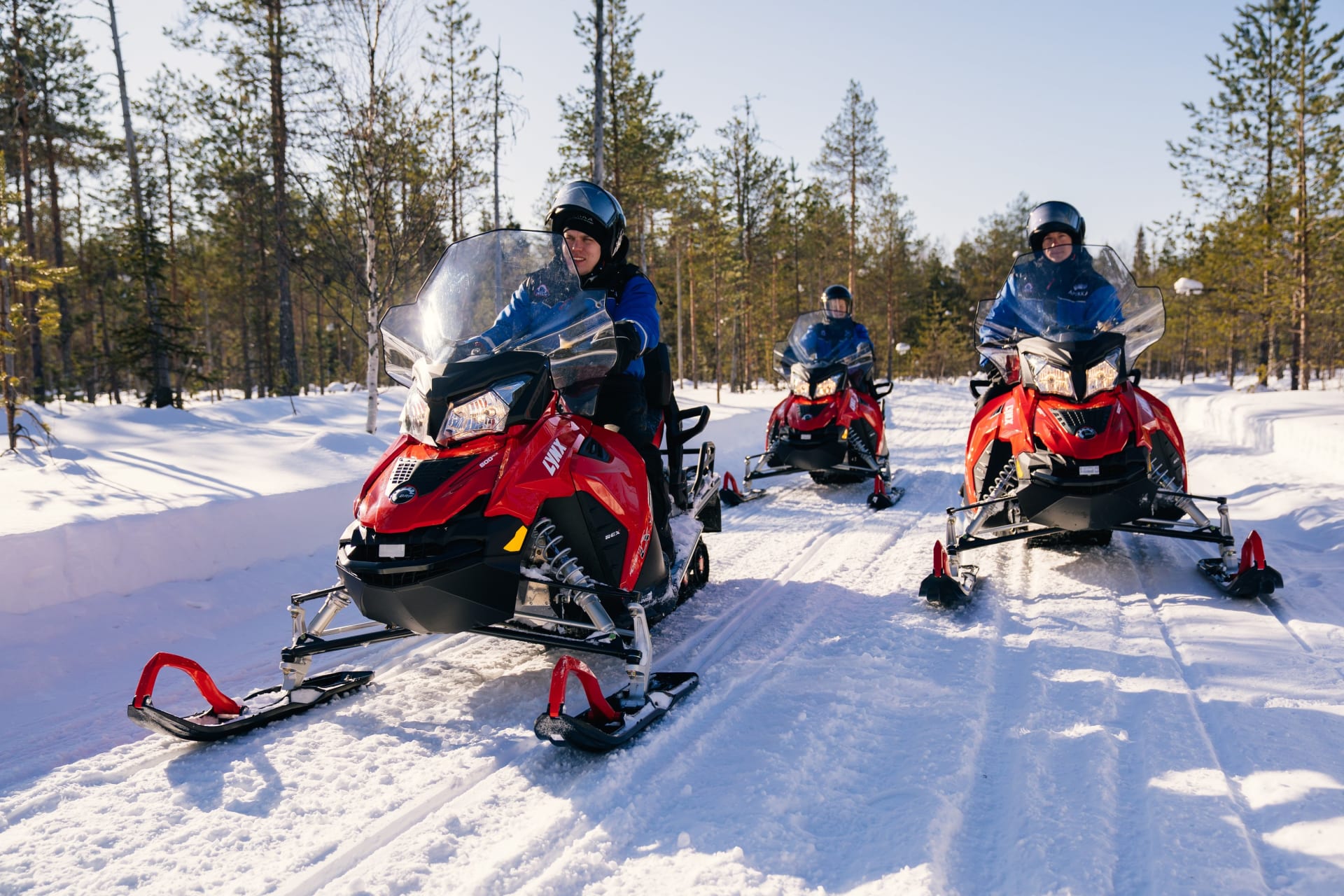 On the way to the ice-fishing spot with snomobiles.