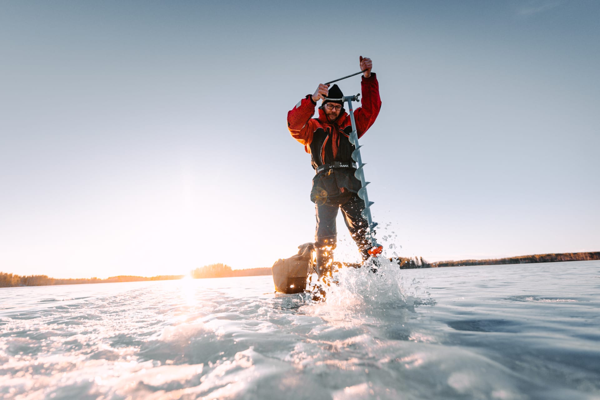 Drilling a hole in the ice