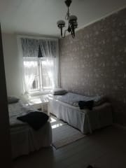 One bed room in Wanhakulma gueshouse Raahe with romantica lace curtains and a bed