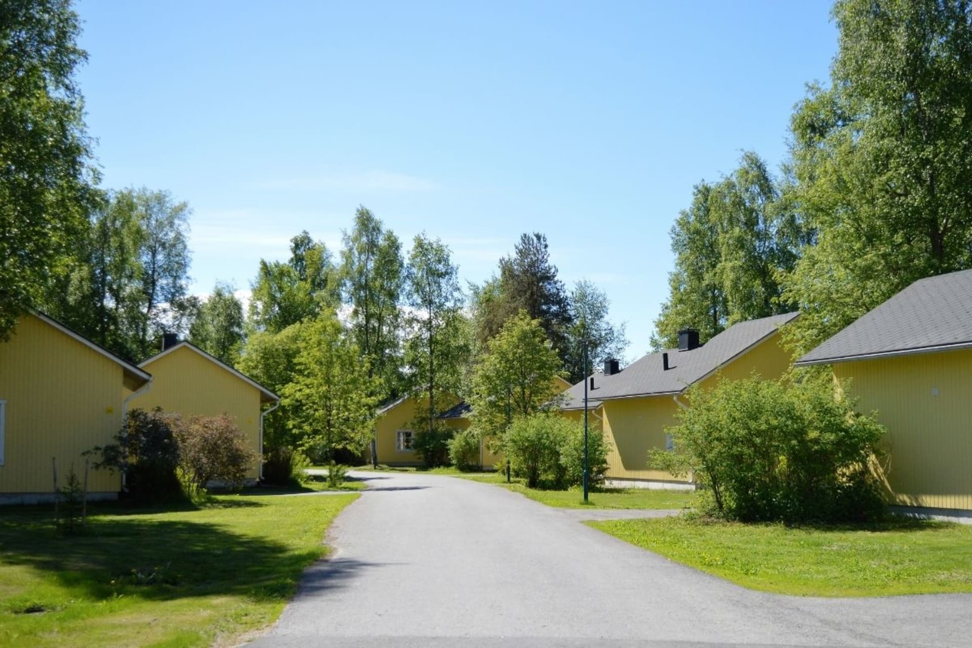 Cottages are yellow and very idyllic outside.