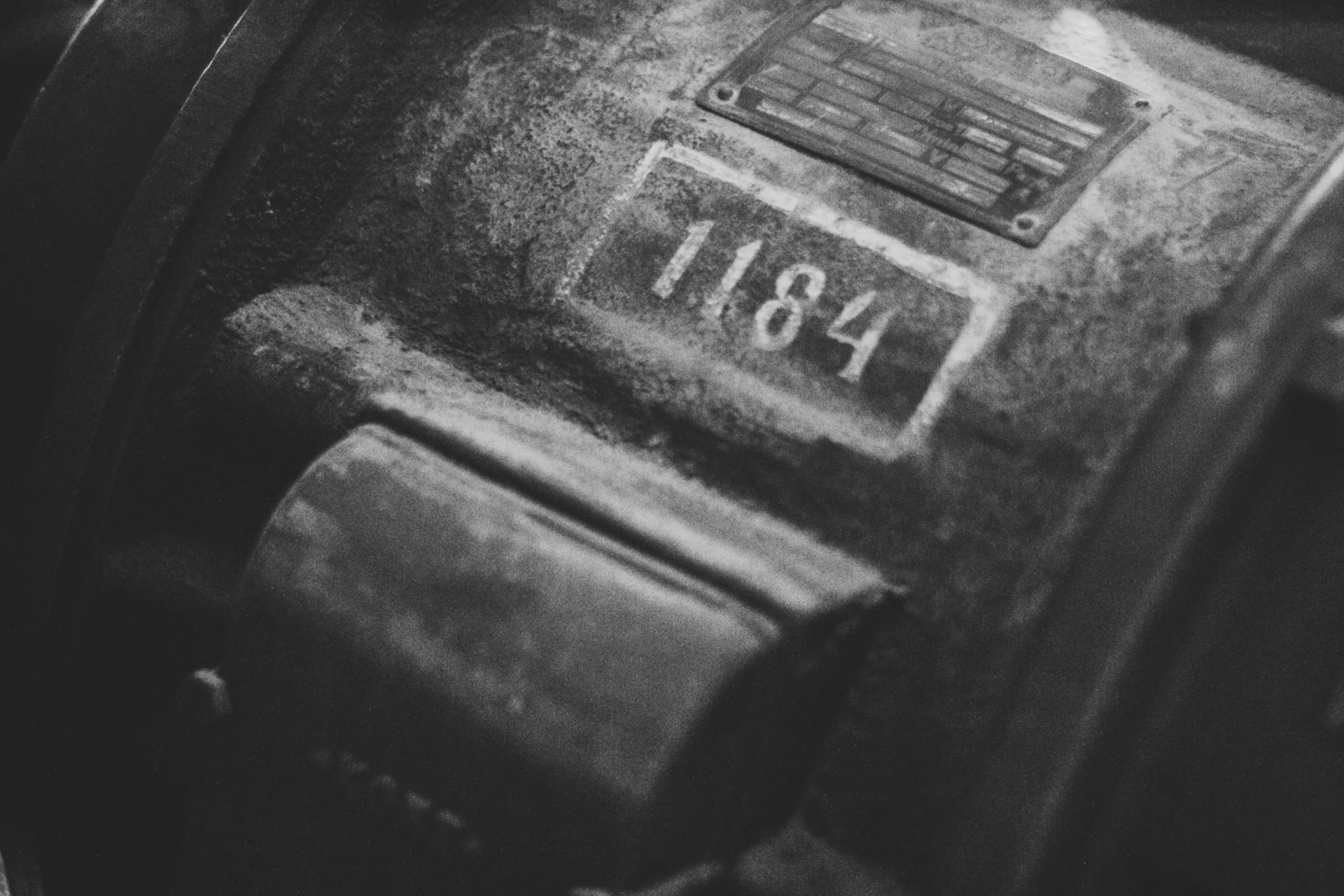 A detail on an old piece of elevator machinery with the numbers 1184