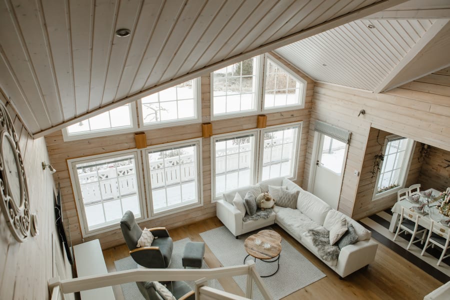 Spacious living room with large landscape windows with a view to Lake Norvajarvi