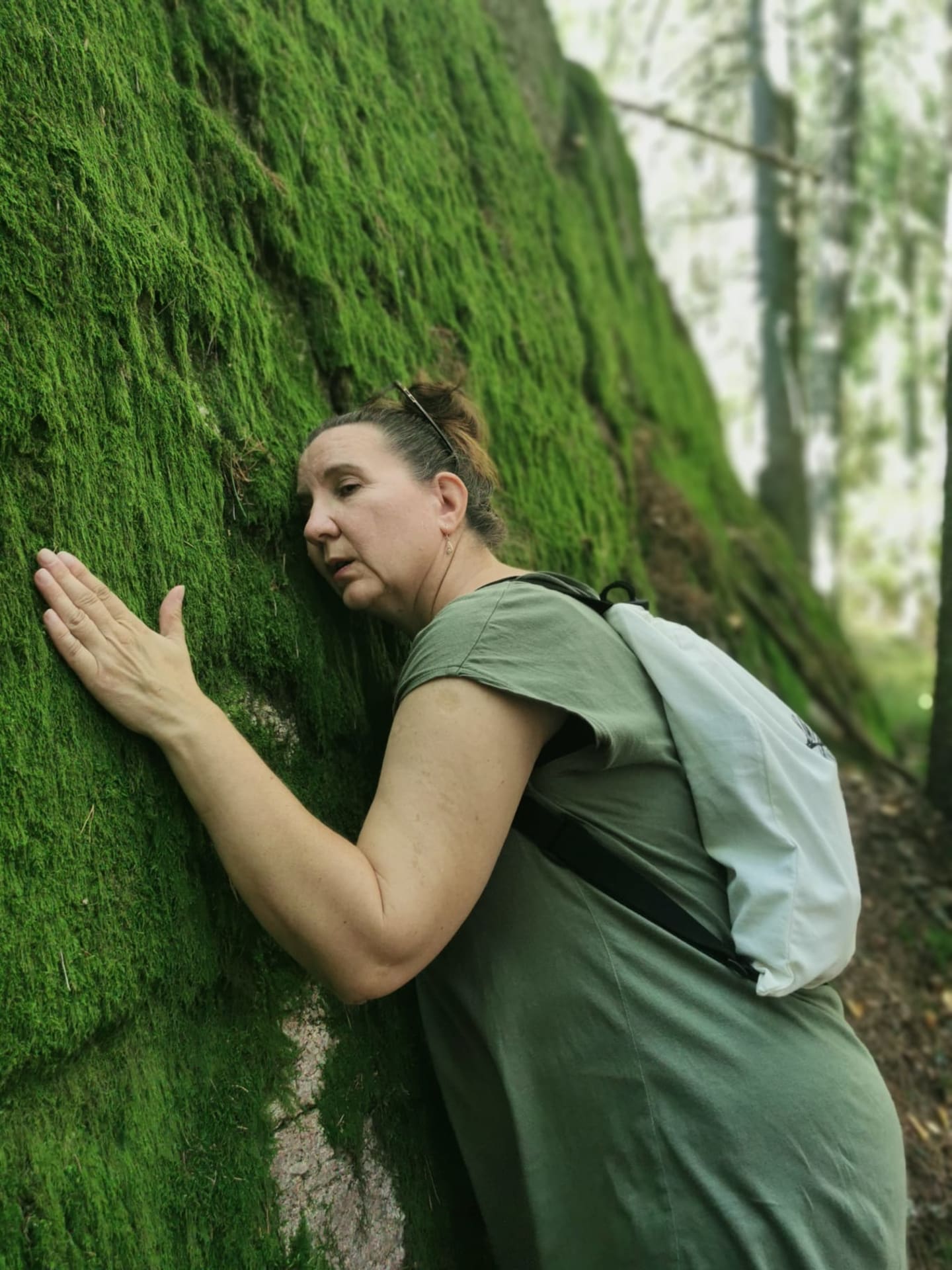 woman feeling the moss