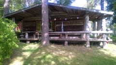 A log sauna building with its big terrace