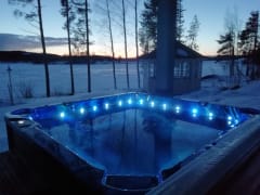Enjoy the warmth and bubbles of the water in Villa Rantakallio's outdoor hot tub.