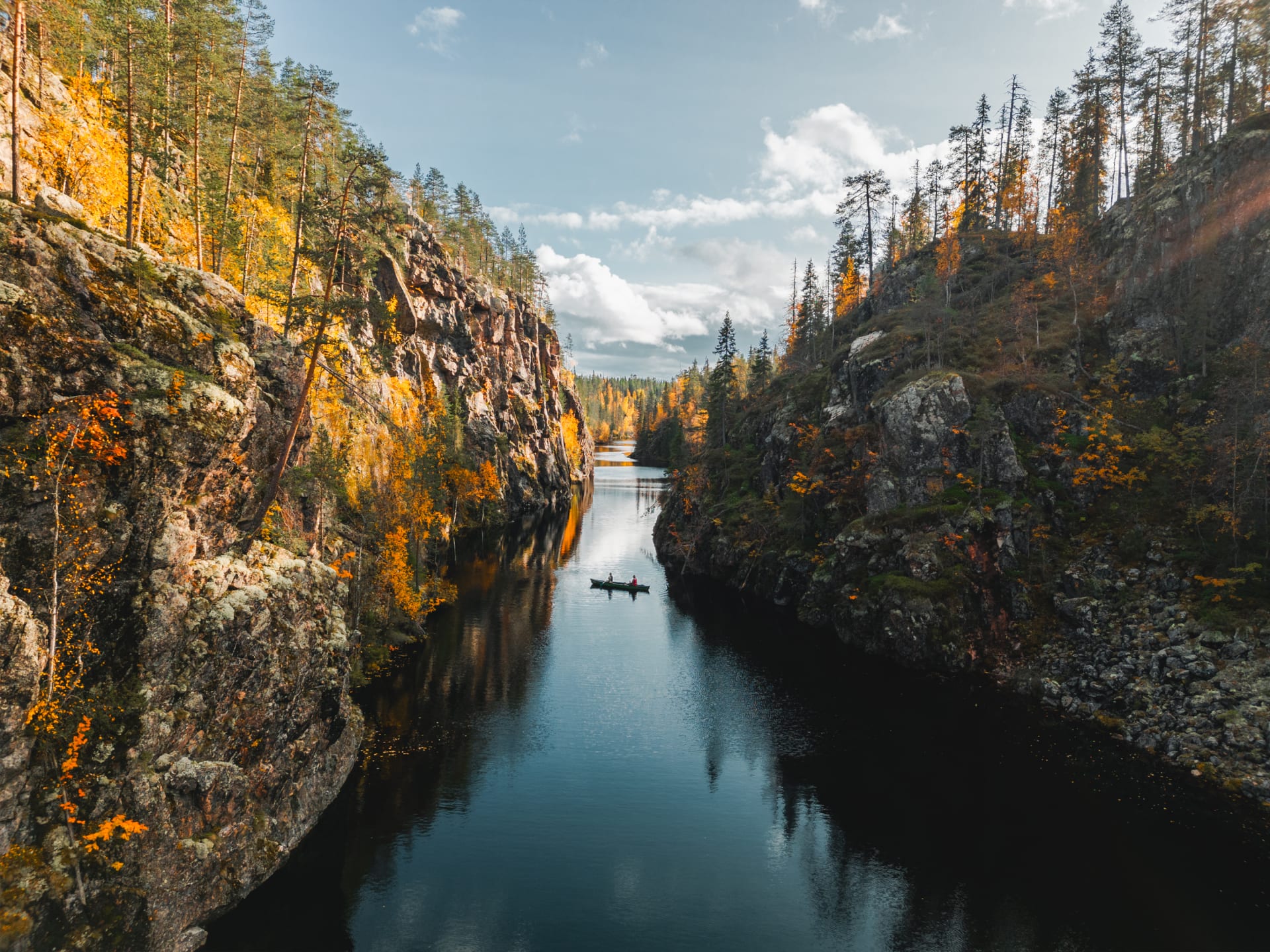 Couple canoeing in the Julma-Ölkky canyon lake in autumn