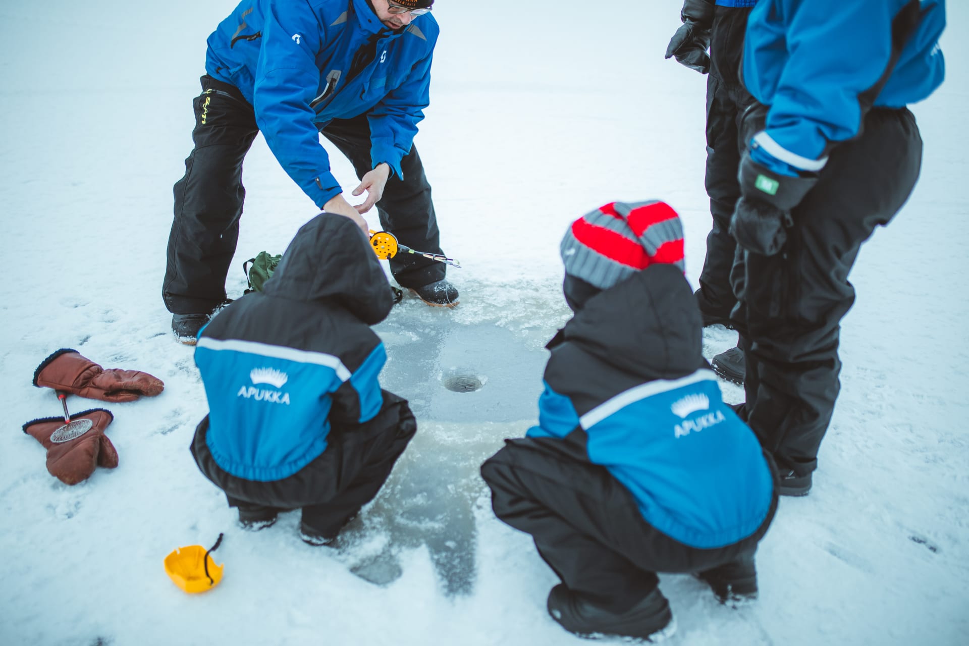 Ice fishing in lake Olkkajärvi near Apukka Resort Rovaniemi