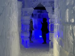 people inside the exhibition made of snow and ice