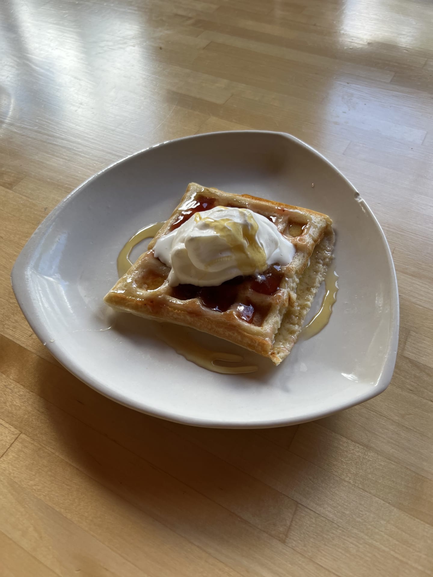 Waffle with strawberry jam and whipped cream