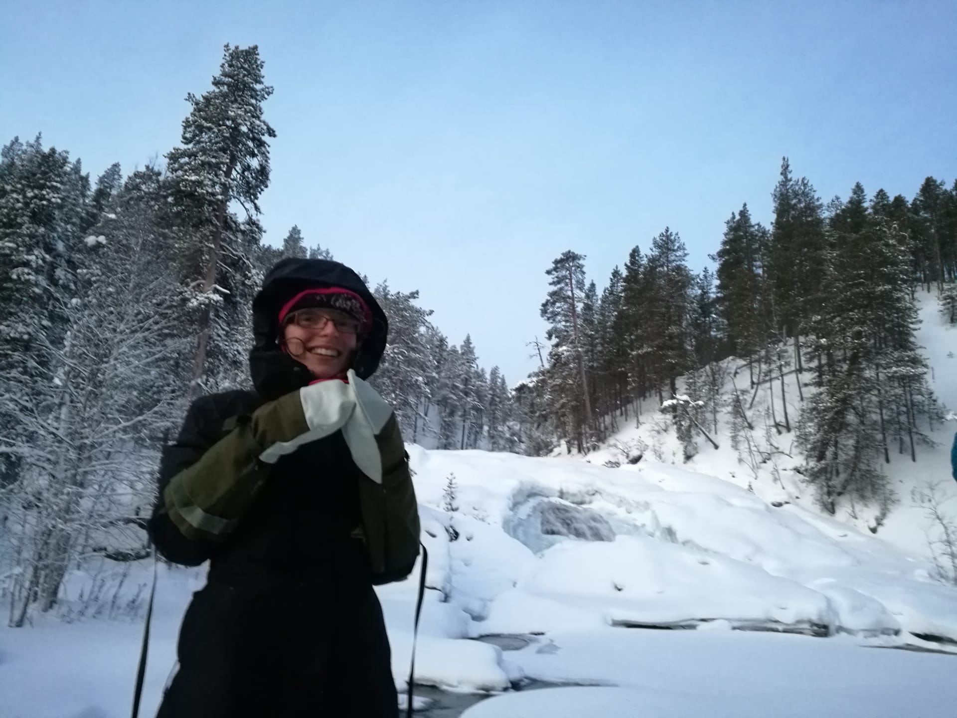 Enjoying a nice hot drink by the frozen waterfall of Ravadasköngäs.