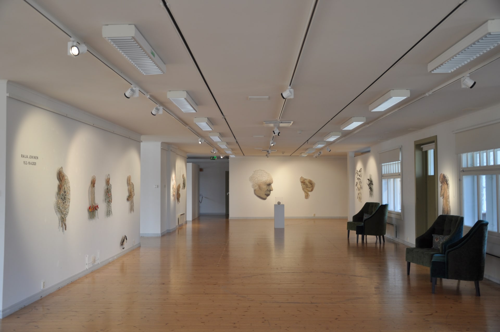 Exhibition hall, artworks and chairs
