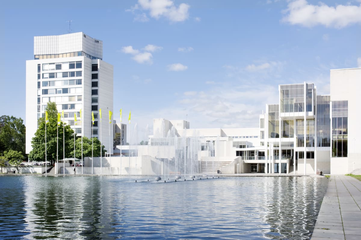Espoo cultural centre and Tapiola central tower buildings photographed from the edge of the Central Pool in summer.