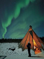 A relaxing moment by a Lappish Lean-to "Kota" while hunting the Northernlights with Apukka Snowtrain.