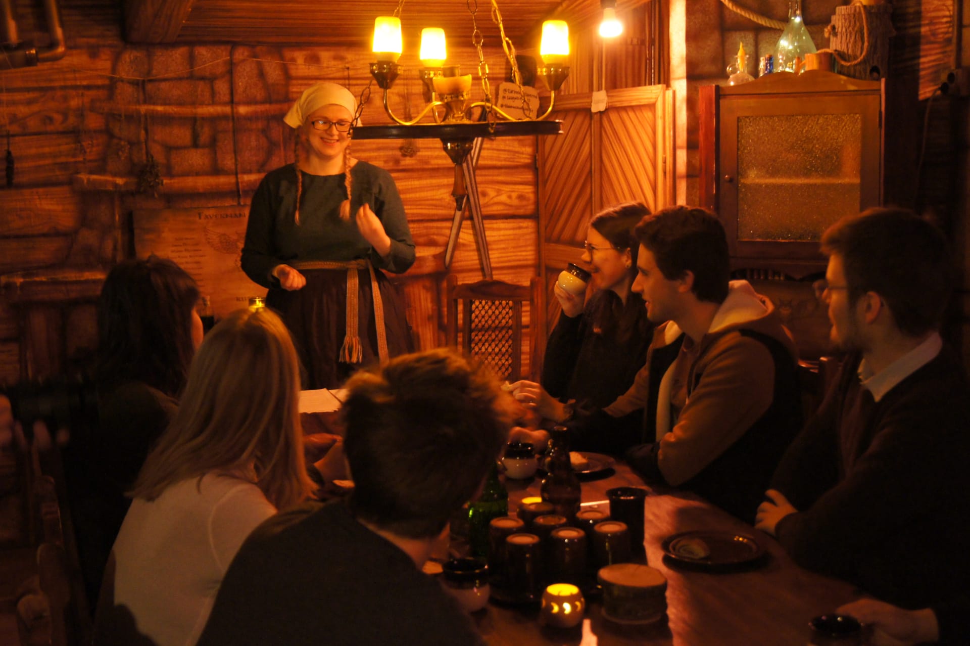 people laughing and listening to storytelling at a fantasy tavern