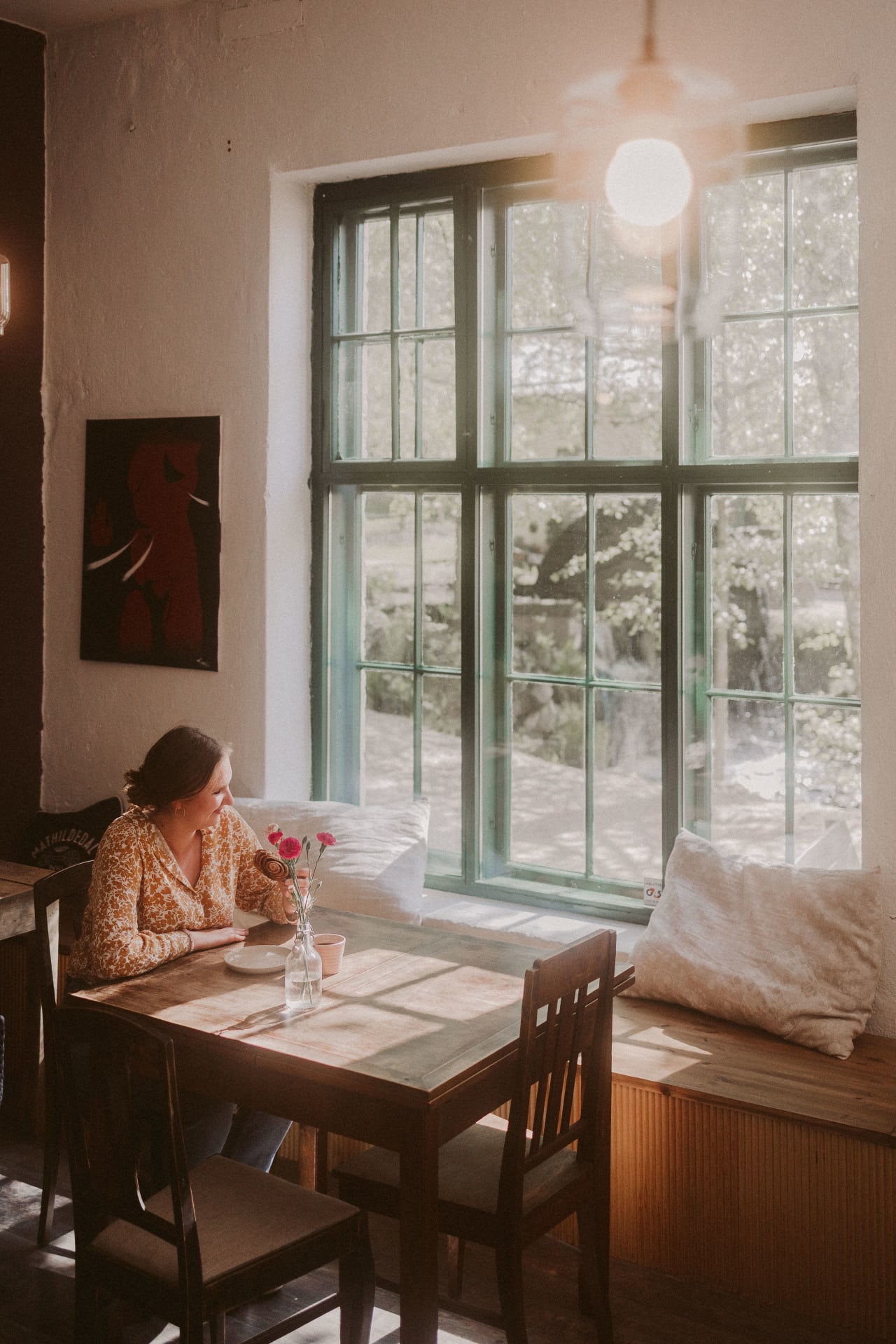 Women enjoying coffee and watching the view from the big windows.