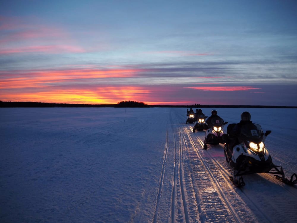 Snowmobile safari in Vuokatti on sunset