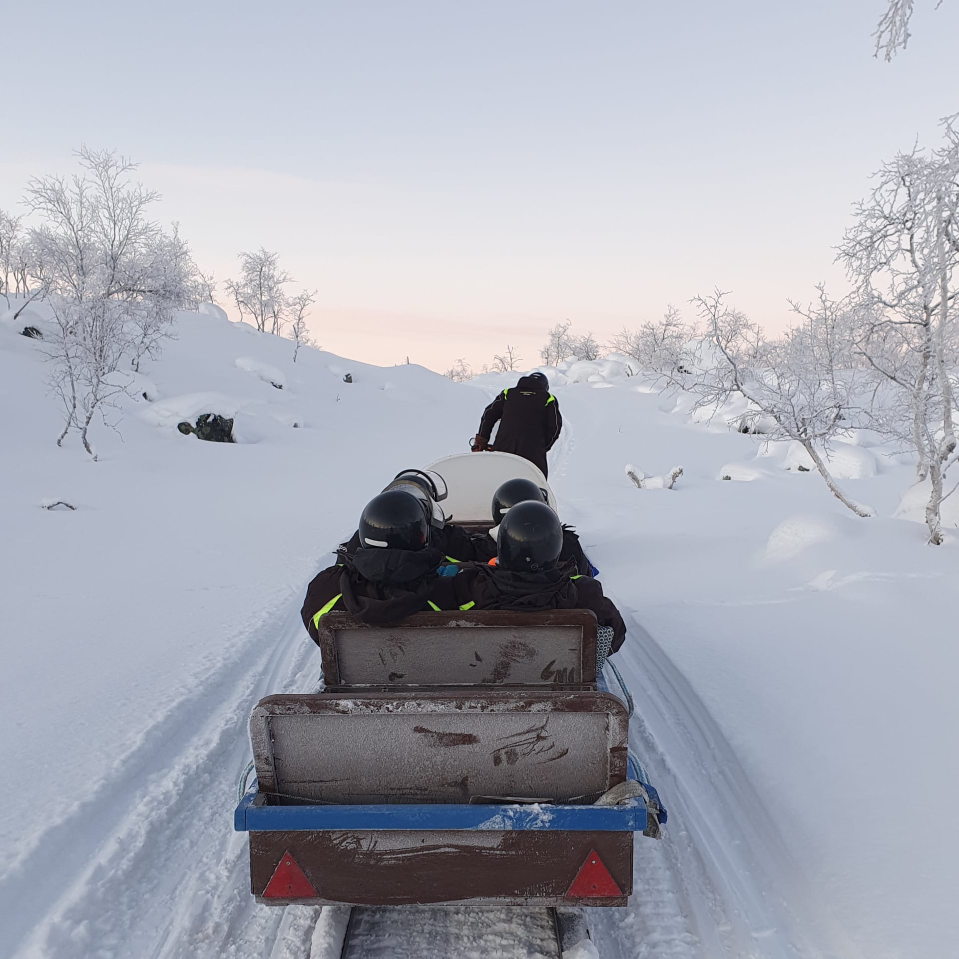 A scenic ride in a snowmobile sledge is included in the village tour