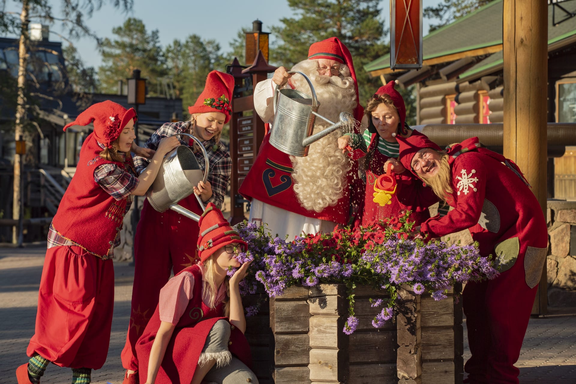 Santa and elves watering flowers