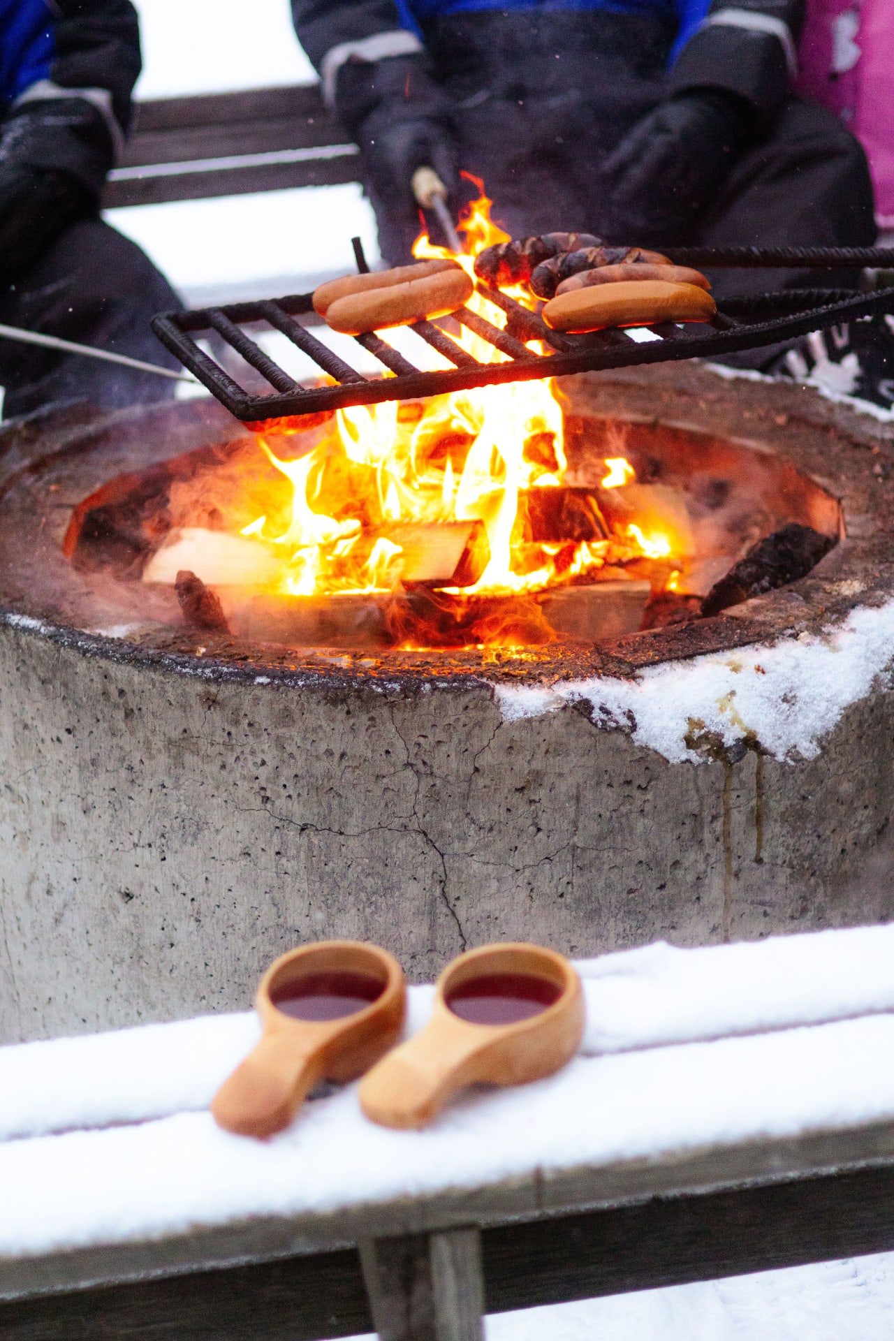 Grilling sausages in outddor BBQ in winter time