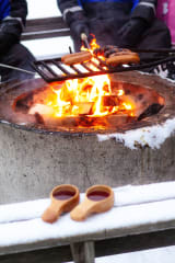 Grilling sausages in outddor BBQ in winter time
