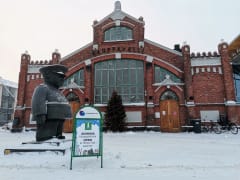 Tourist info sign in front of Market Hall in winter.