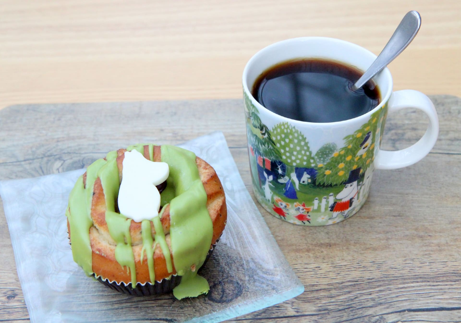 Restaurant Tuhto´s own Moomin coffee mug and a donut with Moomin figure
