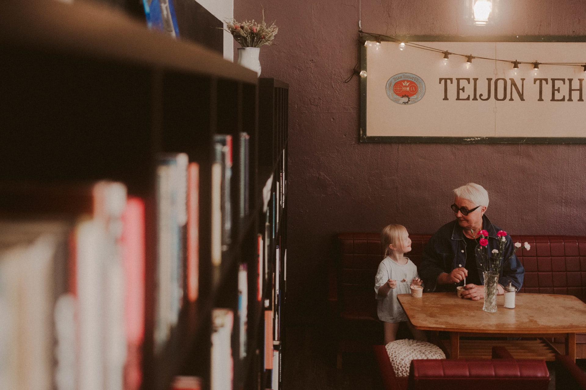 Grand child and grandma eating ice cream and having fun.