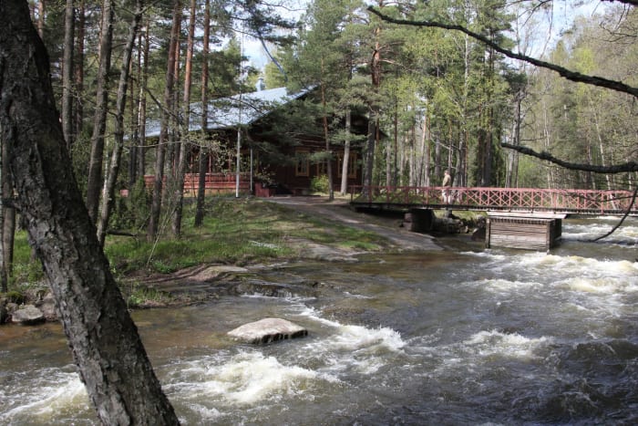 Kuvassa kävelysilta vuolaasti virtaavan kosken yli. Taustalla keisarillinen kalastusmaja. Kuva: Evgeni Usov