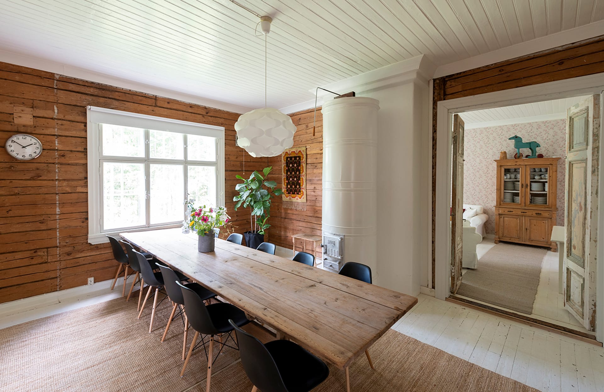 Big wood table with thirteen chairs.