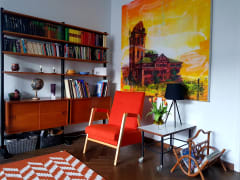 Living room corner with a bookcase and an armchair.