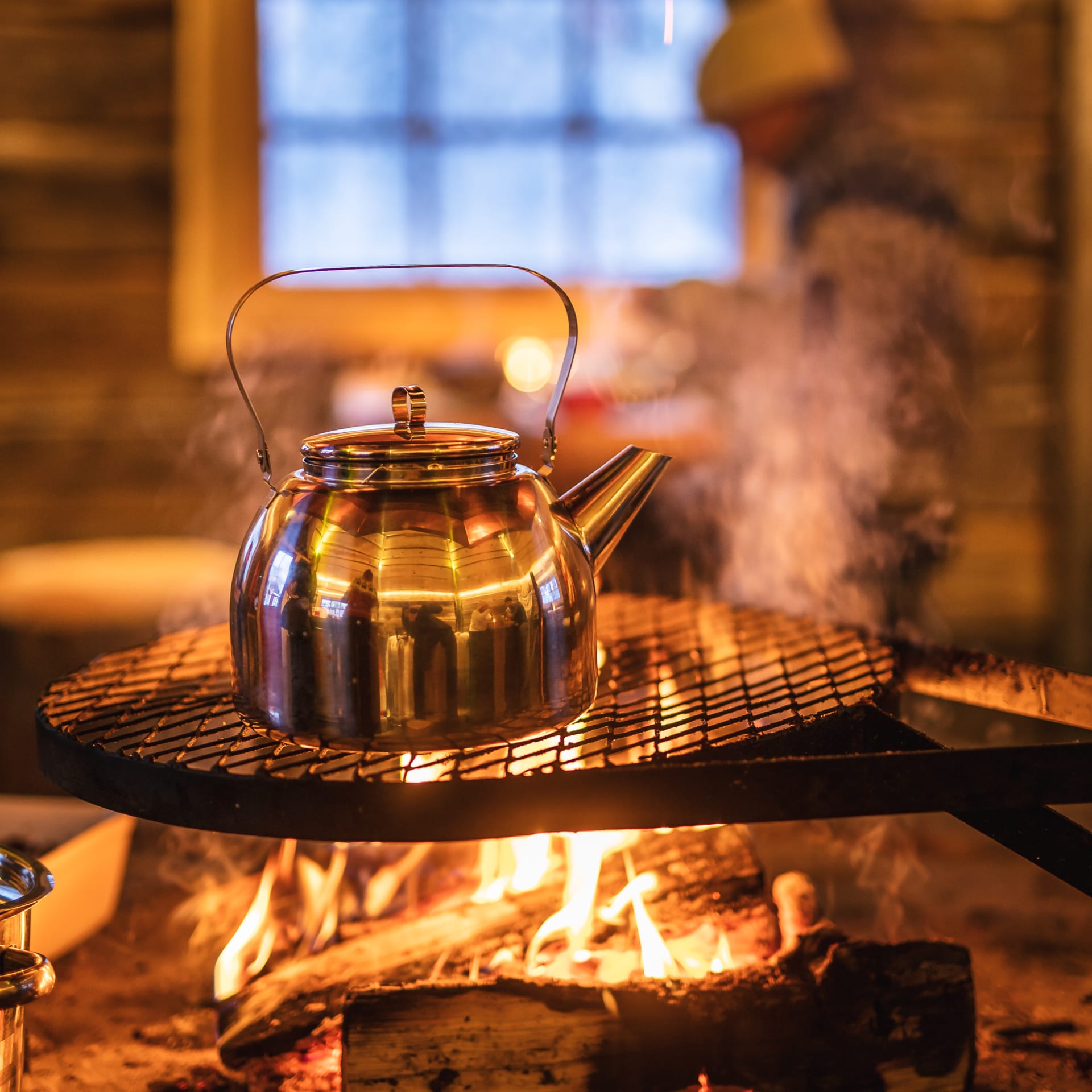 Warm pot of tea by bonfire