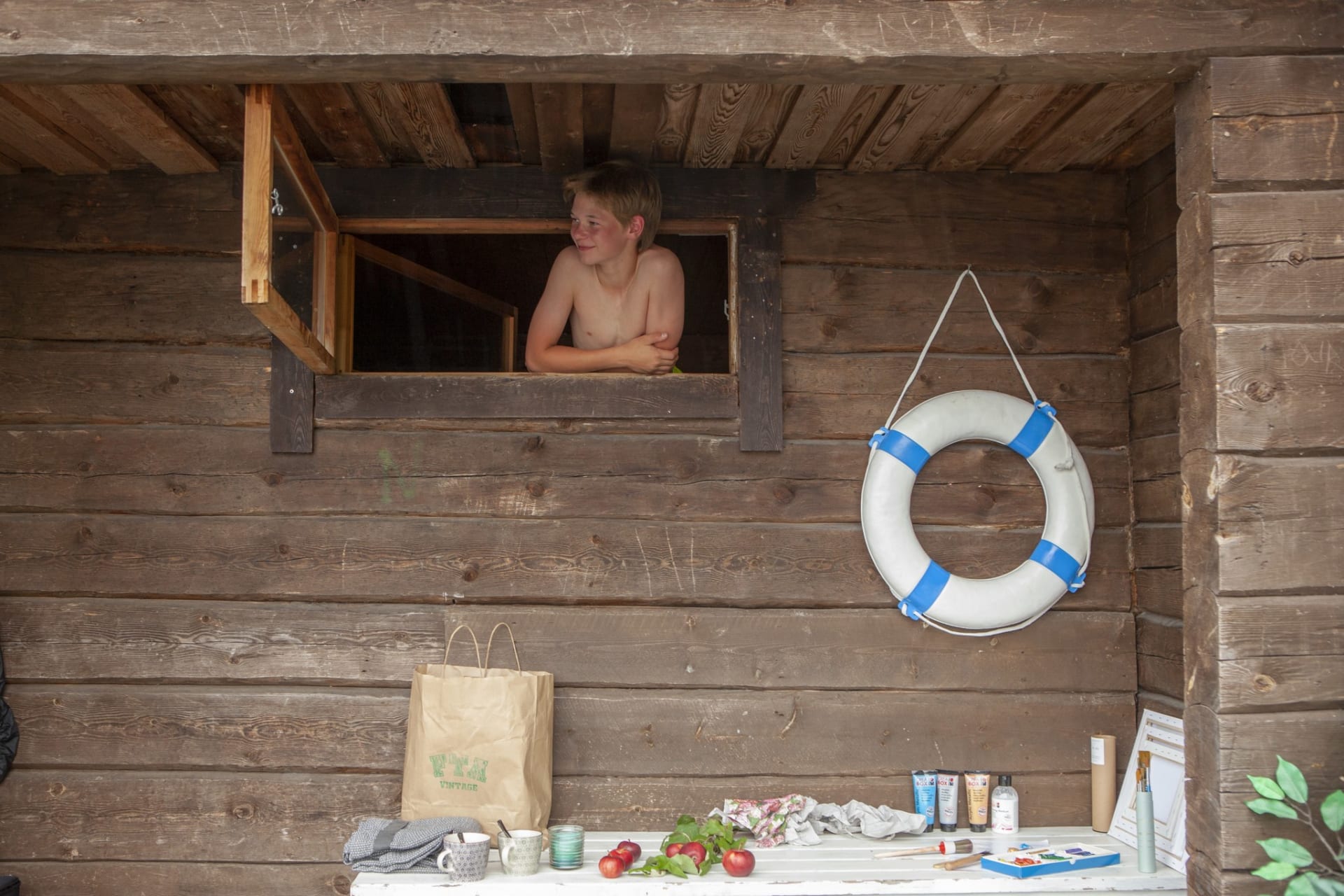A boy is watching out from the sauna window.