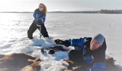 Drilling hole into the ice in lake Apukka