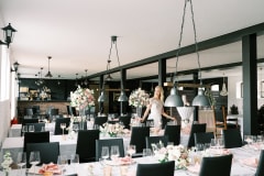 Rows and rows of tables inside the Manor Stables. The venue seats 150 people.