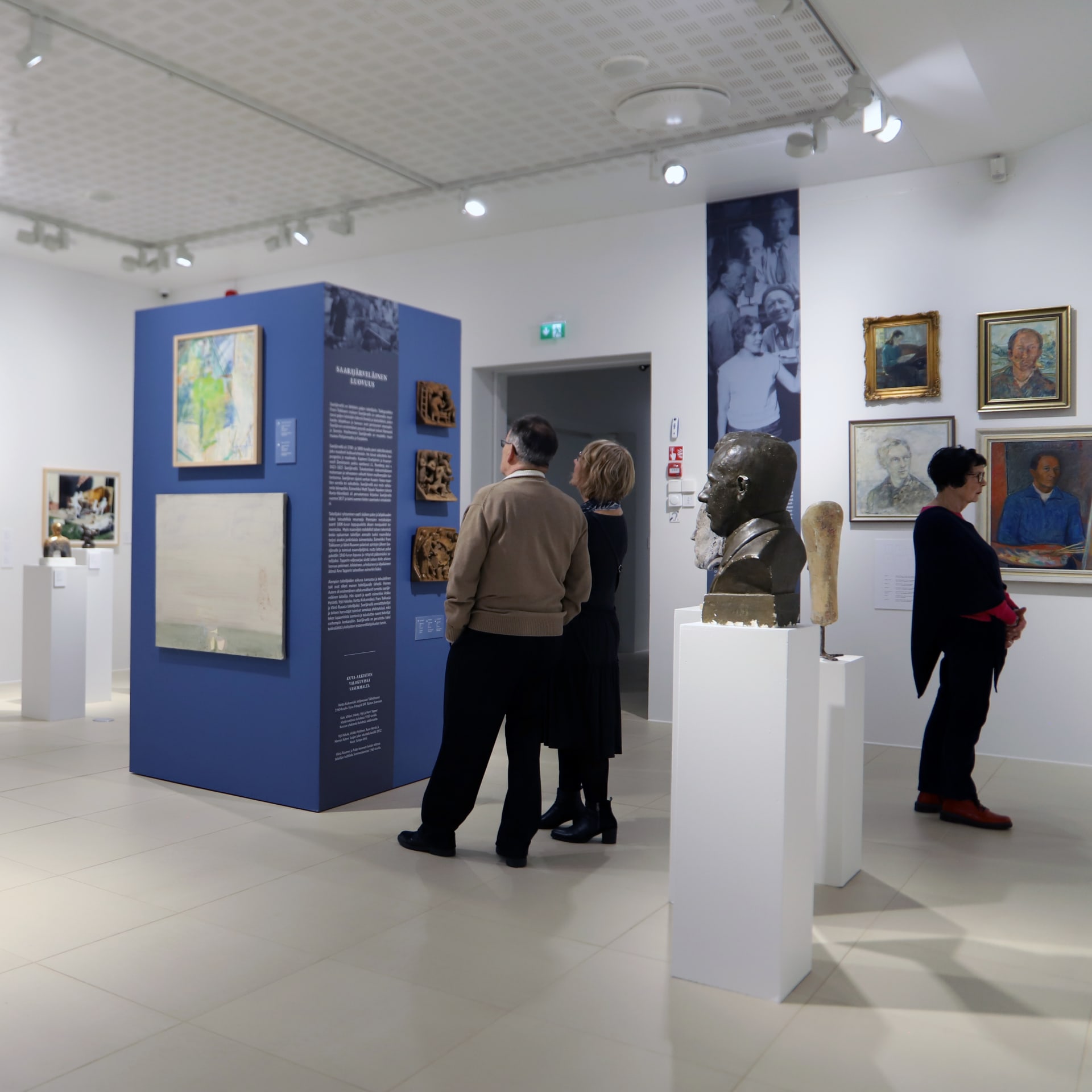 Visitors explore art in the permanent exhibition of Saarijärvi's visual arts.