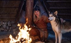 dog and man in leather by the campfire