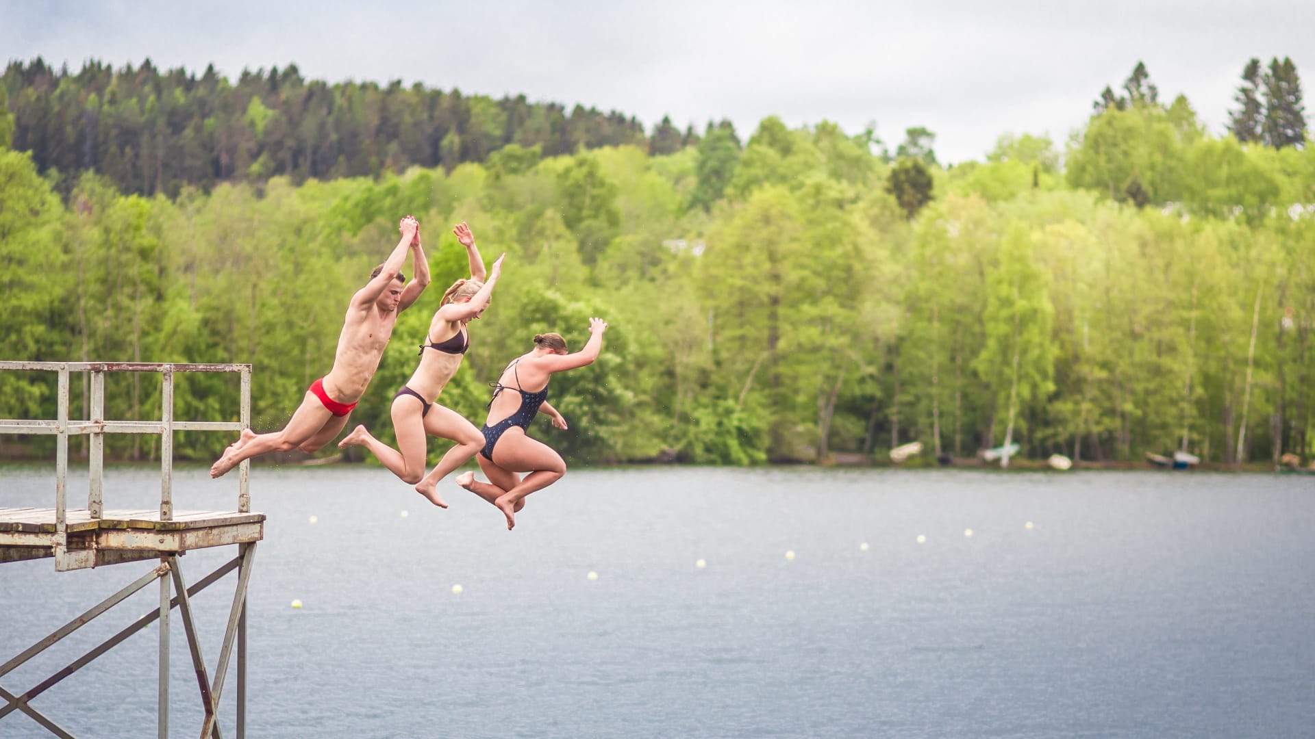People jumping into the lake
