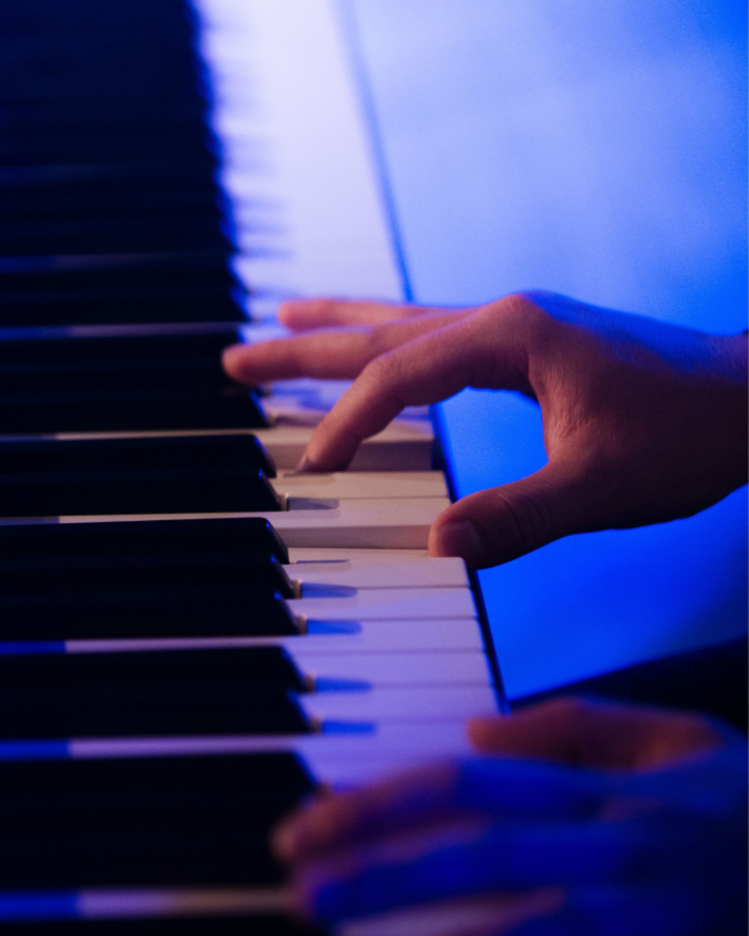 Hand playing piano.