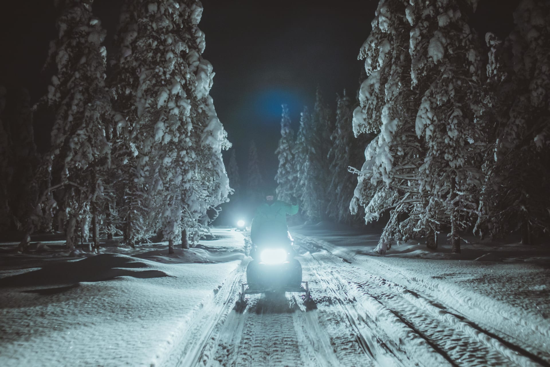 Snowmobiling excursion during nighttime with Apukka Adventures.