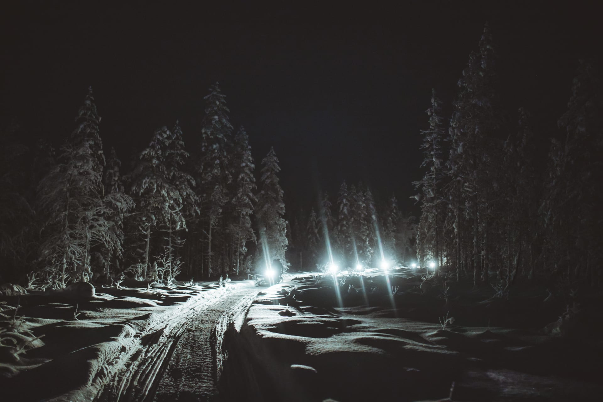 Snowmobiling excursion during nighttime with Apukka Adventures.