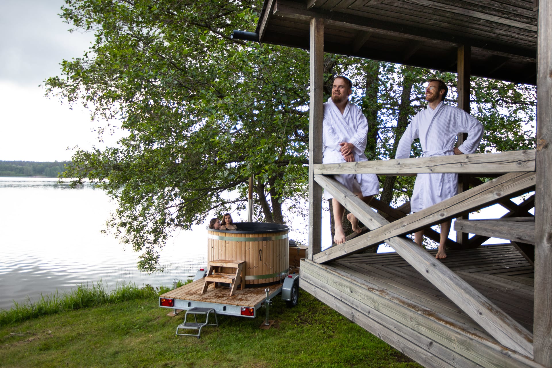 People cooling off after smoke sauna by Lake Tuusula