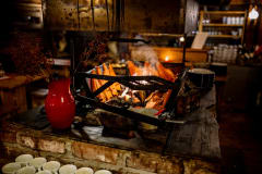 An open fireplace is the heart of the restaurant.