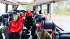 a group of young wolleyball payers inside a bus