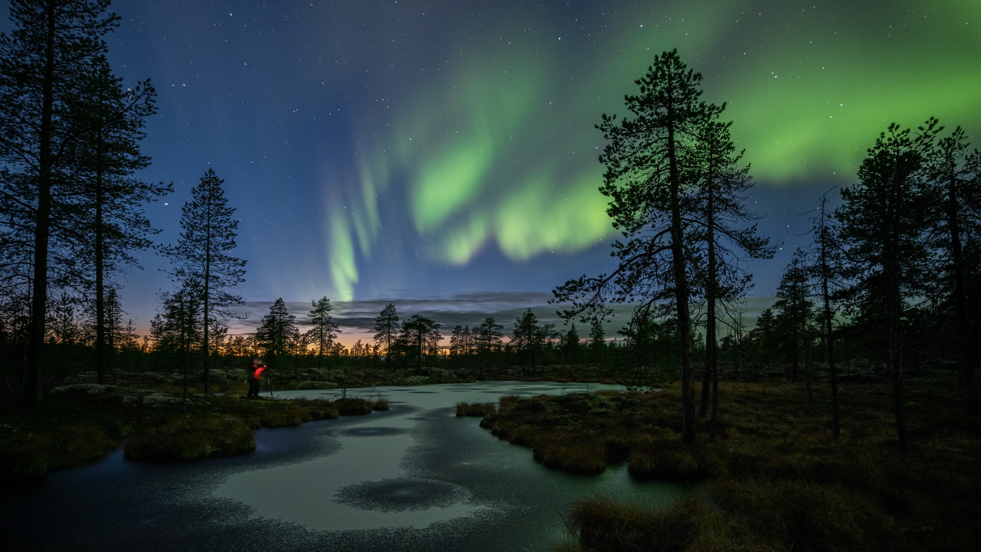 Photographing northern lights at a freshly frozen lake